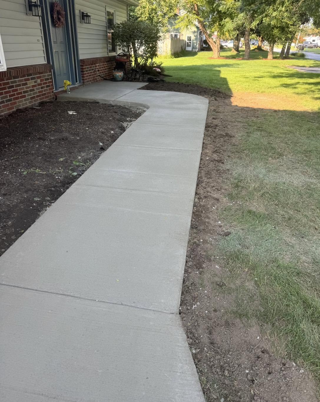 Completed curved concrete front walkway at a Northwest Ohio home